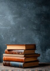 Stacked Books on Wooden Surface Dark Backdrop
