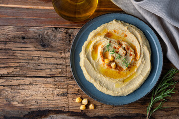 A traditional dish or appetizer hummus or baba ghanoush on wooden background	
