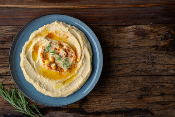 A traditional dish or appetizer hummus or baba ghanoush on wooden background	
