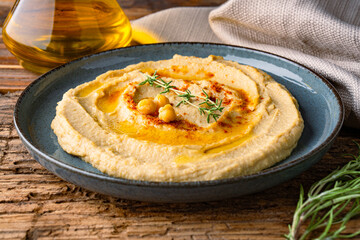 A traditional dish or appetizer hummus or baba ghanoush on wooden background	
