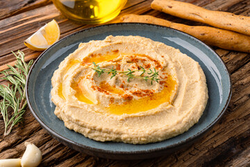 A traditional dish or appetizer hummus or baba ghanoush on wooden background	
