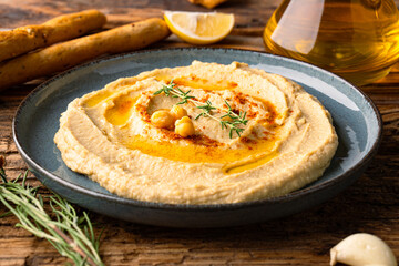 A traditional dish or appetizer hummus or baba ghanoush on wooden background	
