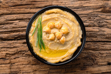 A traditional dish or appetizer hummus or baba ghanoush on wooden background	
