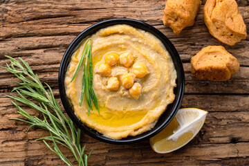 A traditional dish or appetizer hummus or baba ghanoush on wooden background	
