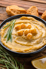 A traditional dish or appetizer hummus or baba ghanoush on wooden background	

