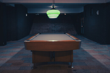 An empty pool table in an empty space