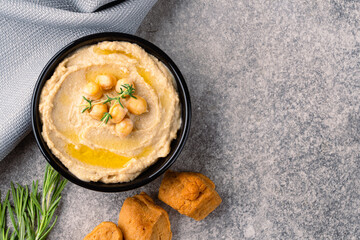 A traditional dish or appetizer hummus or baba ghanoush on vintage background	