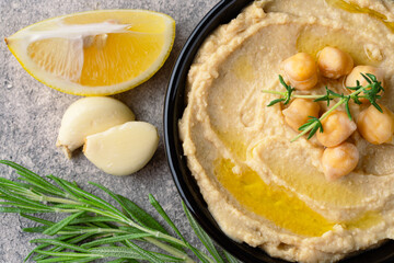 A traditional dish or appetizer hummus or baba ghanoush on vintage background	