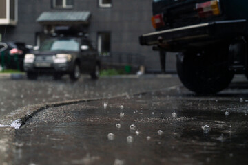 rain in the city, the flow of water along the city street during a downpour, bubbles, drops and...