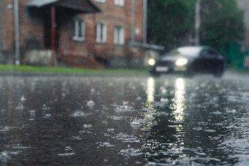 rain in the city, the flow of water along the city street during a downpour, bubbles, drops and...