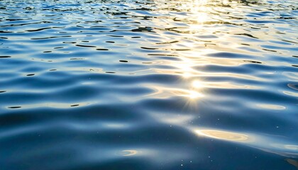 Reflective Blue Water Surface with Sunlight Creating Ripples and Abstract Patterns in Outdoor Setting