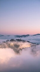 Fototapeta premium Dramatic Mountain Vista Above Dense Cloud Layers at Dusk with Pink Sky