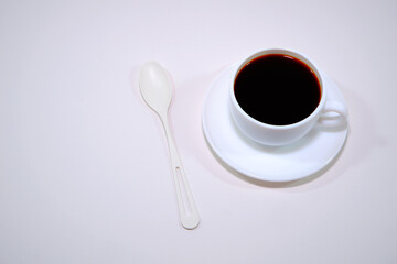 Coffee cup on white background close-up view with copy space 
