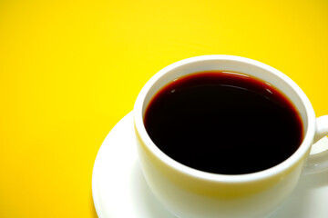 Coffee cup macro photography on yellow background 