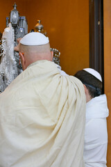 A Bar Mitzvah boy and his father standing by the Torah ark