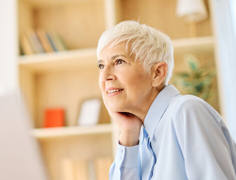 Portrait of an active senior elderly businesswoman during a meeting in the office