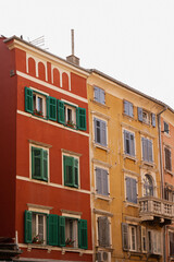 Colorful European Building Facade with Green Shutters and Balcony
