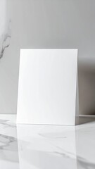 White Square on Marble Tabletop with Soft Lighting and Reflective Surface