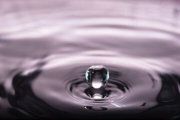 176.Rebounding Water Droplet with Purple Background