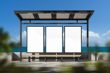 Outdoor bus shelter with three vertical blank posters for advertising mockup on a sunny coastline background with clear blue sky and ocean view. 3D Rendering © ImageFlow