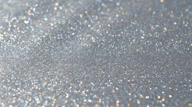 Abstract seamless loop of a glistening silver metallic glitter flowing and rippling like liquid metal abstract background, polished, design