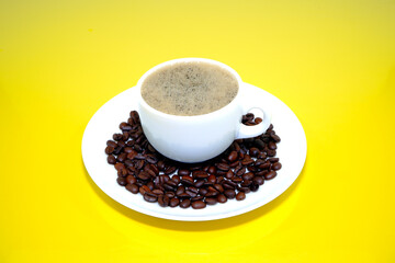 cup of coffee with beans closeup shot on yellow background 