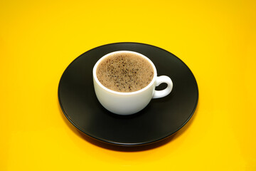 Cup of tea on yellow background close-up view 