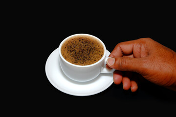 Black coffee holding hand on black background closeup view 