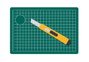 A utility knife rests on a selfhealing cutting mat