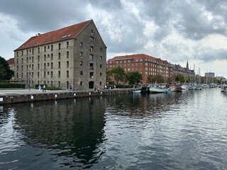 View of Christianshavn with canal, historic buildings and boats in Copenhagen, Denmark, August 2023