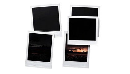 Stacked instant photos, some blank, some showing landscapes at sunset