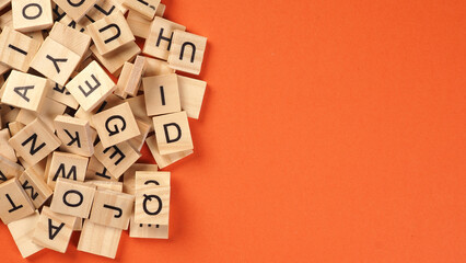 Wooden cube words game isolated on orange background
