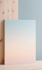 Contemporary still life with a pastel ombre canvas creating a peaceful and simple composition with natural wood textures and soft colors