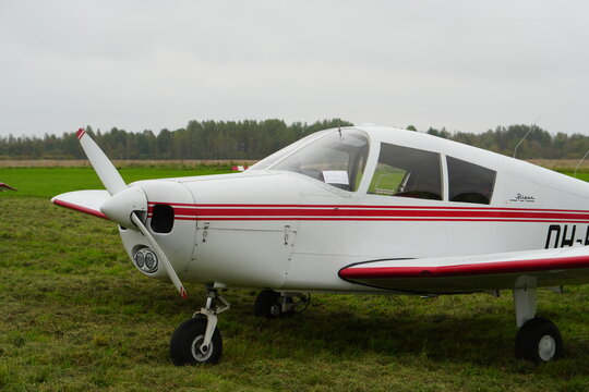 Single-Engine Propeller Plane on a Grassy Airfield