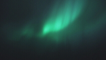 Ethereal green aurora borealis light shimmers and dances across the dark night sky creating a magical atmospheric spectacle.