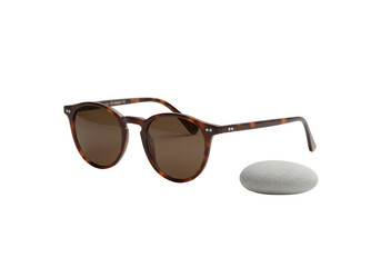 Stylish brown tortoiseshell round-frame sunglasses with dark lenses, next to a smooth pale grey river stone on transparent, bright studio lit, pristine luxury product presentation