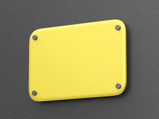 Blank yellow metal nameplate on dark grey wall