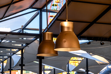 Lamps with iron shades hang from the ceiling of the cafe.