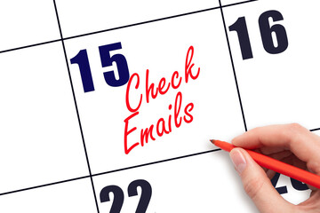 15 th day of the month.  Hand writing Check emails reminder on calendar with red pen on white...