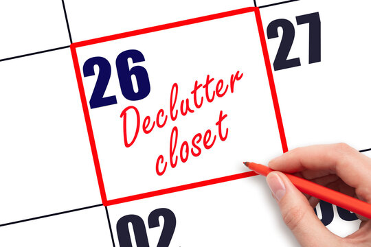 26 th day of the month.  Hand writing Declutter closet reminder and drawing red frame on calendar with red pen on white background. Cleaning concept. Planning and scheduling