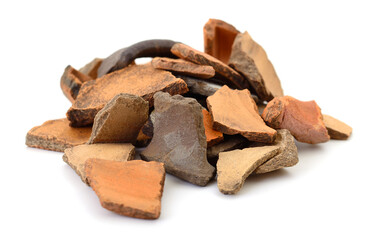 Pile of broken ceramic shards isolated on white background
