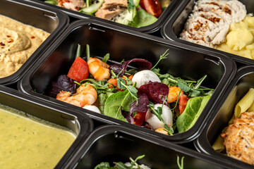 Meal prep container with shrimp salad, mozzarella, and fresh greens