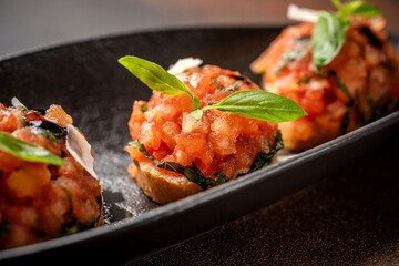 Italian bruschetta with tomatoes, basil, and parmesan on toasted bread