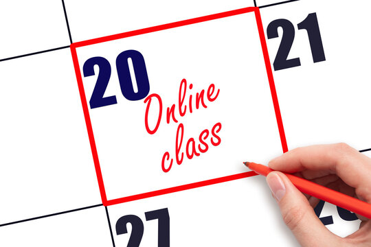 20 th day of the month.  Hand writing Online class reminder and drawing red frame on calendar with red pen on white background. Online education concept. Planning and scheduling