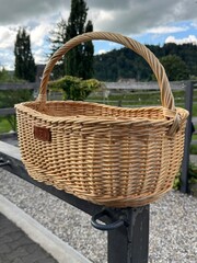 Empty Wicker Basket Outdoors on a Country Fence
