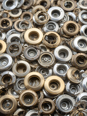 Obraz premium Collection of Metallic Eyelets: Brass, Silver, and Chrome Grommets for Banners and Crafting