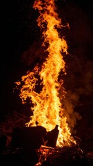 Dramatic Vertical Fire Flames Reaching Upward in the Dark of Night