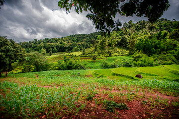 natural backdrop with large mountains surrounding it,a clear sky with clouds flowing through, cool breeze blowing through the viewpoints at famous tourist attractions.An adventure during the journey.