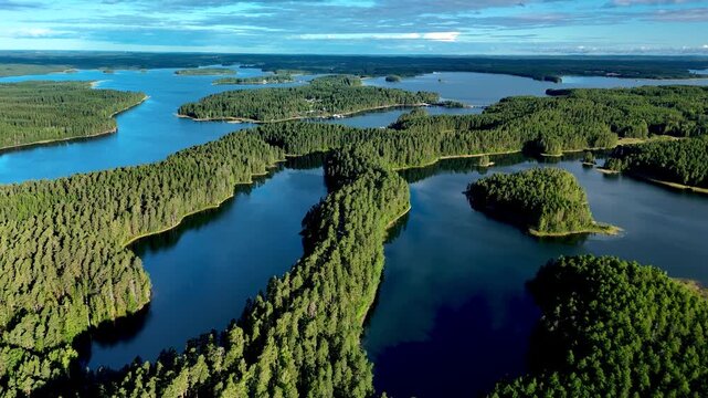 Nestled in Finland, Punkaharju features stunning esker bridges that connect tranquil lakes and dense forests roads, Punkaharju Nature Reserve, drone aerial view above the road in nature
