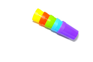 Colorful plastic tumblers together isolated on white background close-up view 